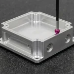 Precision CNC prototype aluminum housing on granite surface plate during dimensional metrology inspection