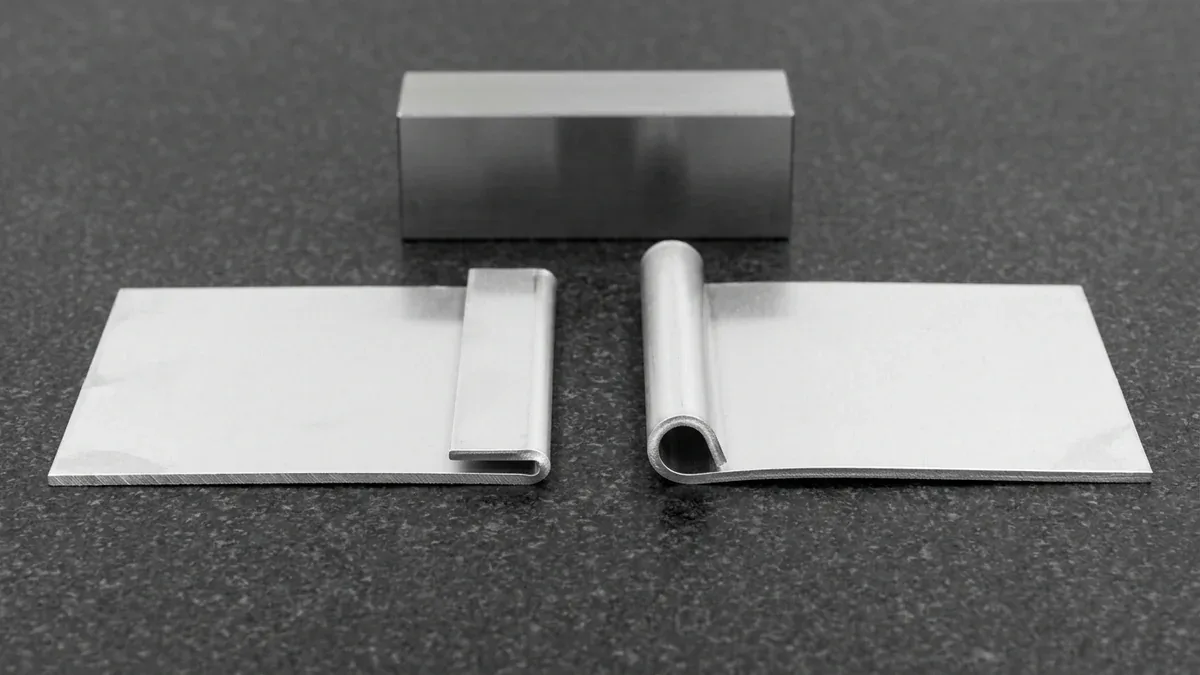 Industrial macro comparison of precision sheet metal teardrop hem and open hem folds for edge reinforcement
