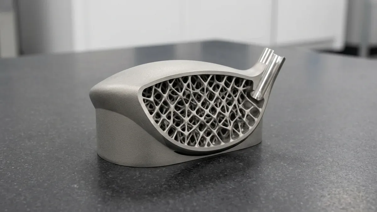 DMLS 3D-printed Ti-6Al-4V titanium aerodynamic golf driver clubhead cutaway showcasing an internal trabecular lattice core