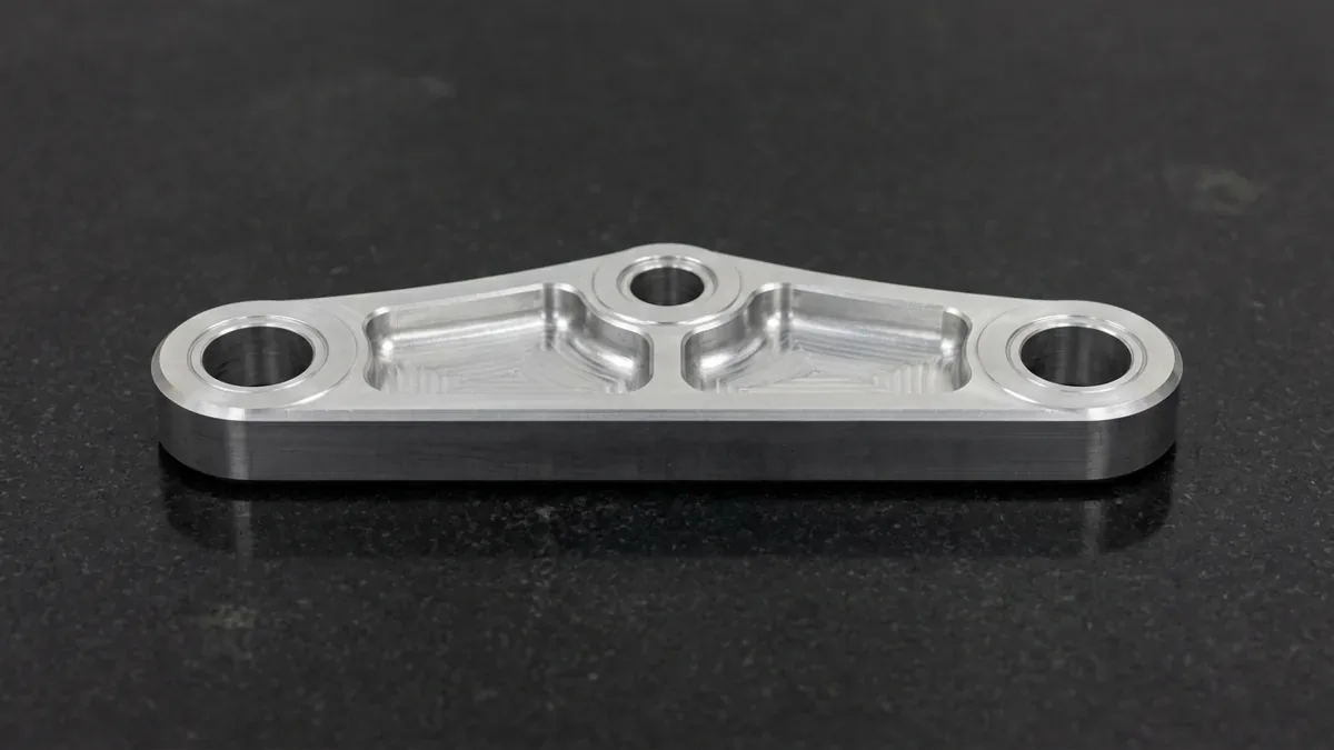 3-axis CNC-machined billet 6061-T6 aluminum motorcycle rear suspension linkage arm with reamed bores