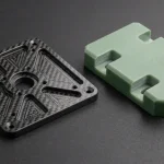 CNC-machined 5.0mm 3K twill CFRP carbon fiber gimbal plate beside 6.0mm G10 glass-epoxy insulator manifold