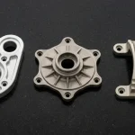 CNC machined 7075-T651 aluminum link plate, Ti-6Al-4V titanium rotary flange, and AZ31B magnesium saddle clamp