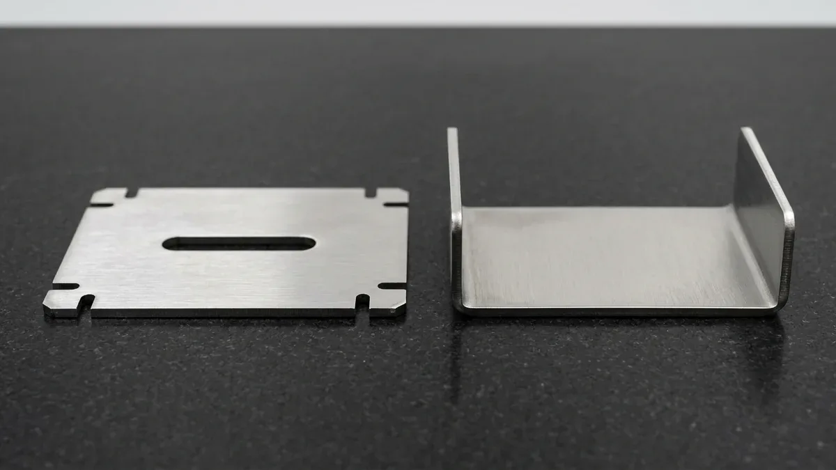 Laser-cut 2.0mm 304 stainless steel flat-pattern sheet metal blank beside press-brake formed U-channel bracket