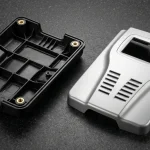 Reaction Injection Molded polyurethane diagnostic enclosures on granite showing ribbed walls and brass threaded inserts.